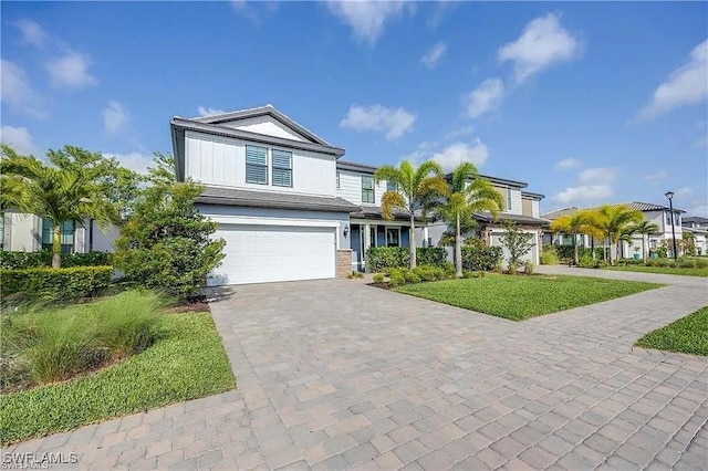 10367 Ventana Ln, Naples, FL 34120 - view of front of house with decorative driveway and an attached garage