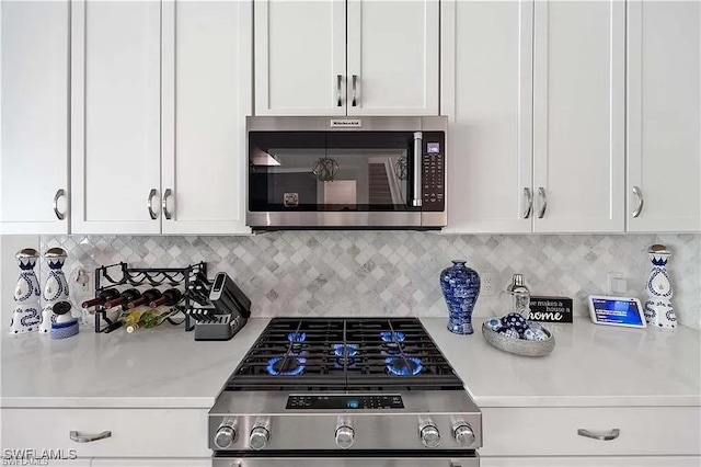10367 Ventana Ln, Naples, FL 34120 - kitchen with appliances with stainless steel finishes, light countertops, and white cabinetry