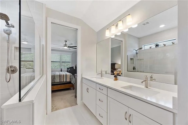 10367 Ventana Ln, Naples, FL 34120 - bathroom with connected bathroom, tiled shower, a ceiling fan, double vanity, and vaulted ceiling
