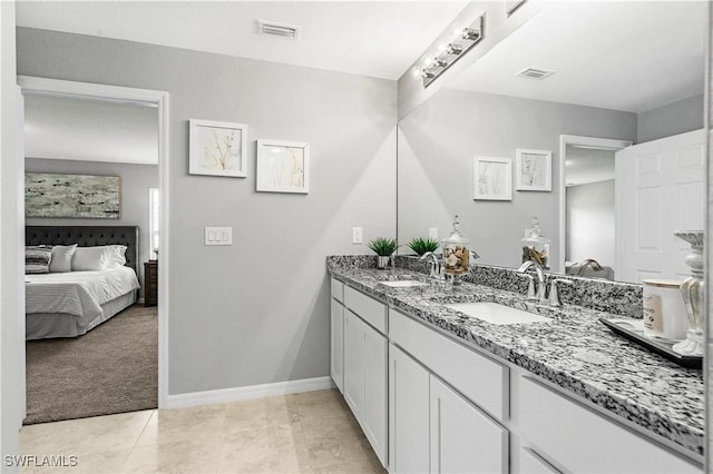 722 SW 7th Ter, Cape Coral, FL 33991 - full bath featuring ensuite bathroom, double vanity, baseboards, and tile patterned floors