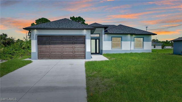 3808 2nd St W, Lehigh Acres, FL 33971 - view of front of home featuring concrete driveway, an attached garage, a front lawn, and stucco siding