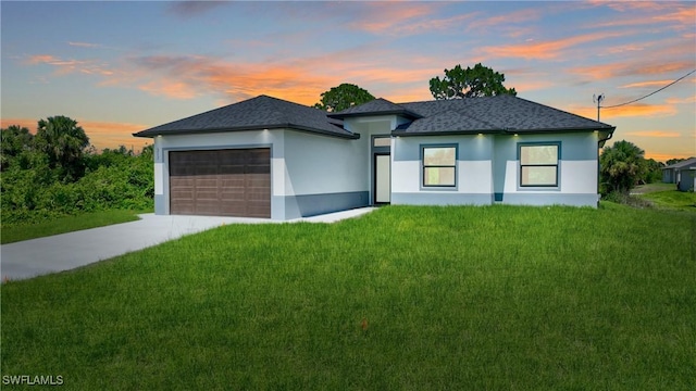3808 2nd St W, Lehigh Acres, FL 33971 - prairie-style home with a garage, concrete driveway, a yard, and stucco siding