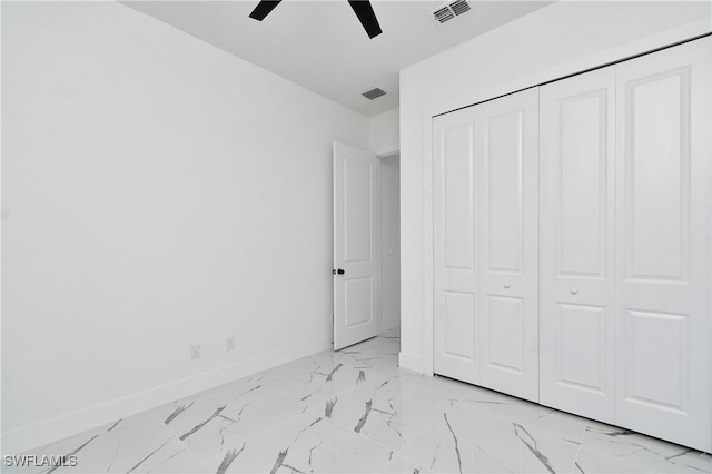 3808 2nd St W, Lehigh Acres, FL 33971 - unfurnished bedroom featuring light marble finish floors, baseboards, a closet, and ceiling fan