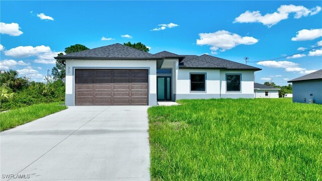 3808 2nd St W, Lehigh Acres, FL 33971 - view of front facade with stucco siding, an attached garage, concrete driveway, and a front lawn