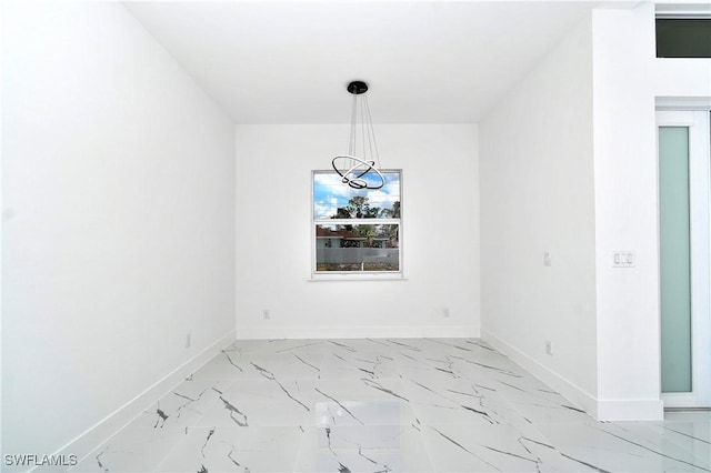 3808 2nd St W, Lehigh Acres, FL 33971 - unfurnished room featuring a chandelier, baseboards, and light marble finish flooring