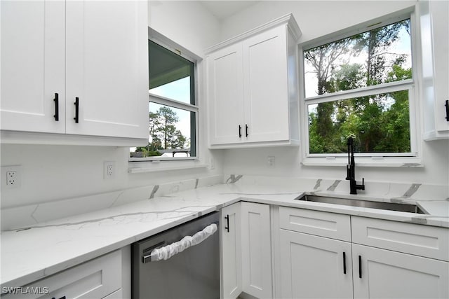 3808 2nd St W, Lehigh Acres, FL 33971 - kitchen featuring stainless steel dishwasher, a sink, and white cabinets