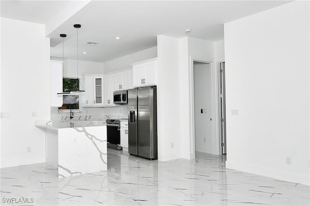 3808 2nd St W, Lehigh Acres, FL 33971 - kitchen with stainless steel appliances, light marble finish flooring, a peninsula, white cabinetry, and recessed lighting
