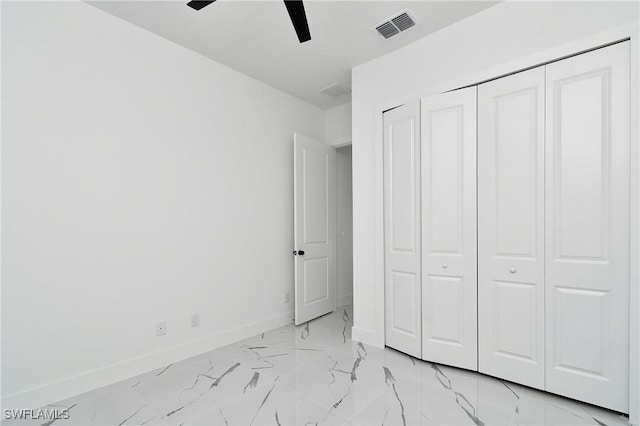 3808 2nd St W, Lehigh Acres, FL 33971 - unfurnished bedroom featuring baseboards, light marble finish floors, a closet, and a ceiling fan