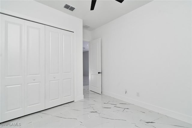 3808 2nd St W, Lehigh Acres, FL 33971 - unfurnished bedroom featuring light marble finish floors, baseboards, a closet, and ceiling fan