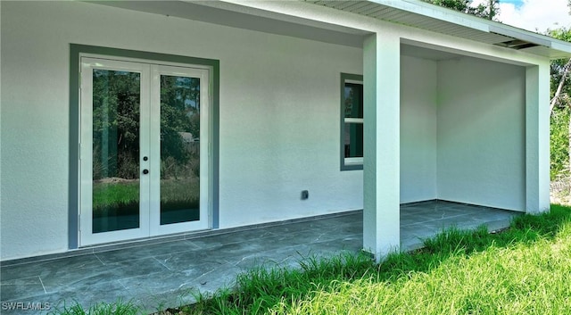 3808 2nd St W, Lehigh Acres, FL 33971 - view of side of property featuring french doors, stucco siding, and a patio area