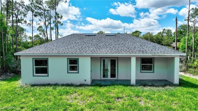 3808 2nd St W, Lehigh Acres, FL 33971 - back of house with roof with shingles, a yard, and stucco siding