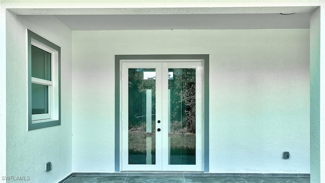 3808 2nd St W, Lehigh Acres, FL 33971 - entrance to property with french doors and stucco siding