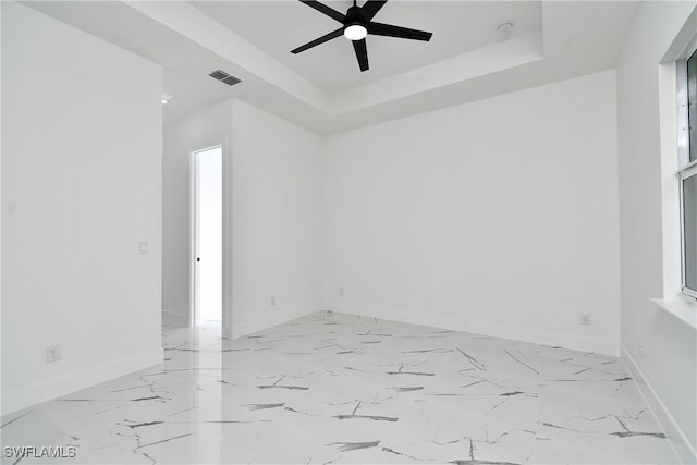3808 2nd St W, Lehigh Acres, FL 33971 - empty room featuring a ceiling fan, baseboards, a raised ceiling, a smoke detector, and light marble finish flooring