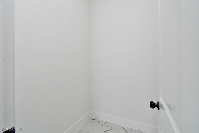3808 2nd St W, Lehigh Acres, FL 33971 - laundry room featuring baseboards and light marble finish flooring