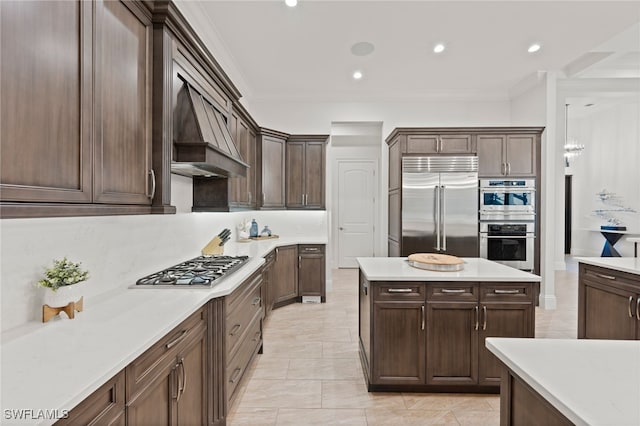 4249 Deephaven Ln, Naples, FL 34119 - kitchen with stainless steel appliances, recessed lighting, dark brown cabinetry, light countertops, and ornamental molding