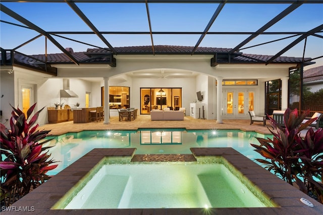 4249 Deephaven Ln, Naples, FL 34119 - rear view of property with a pool with connected hot tub, an outdoor living space, a tile roof, french doors, and a patio