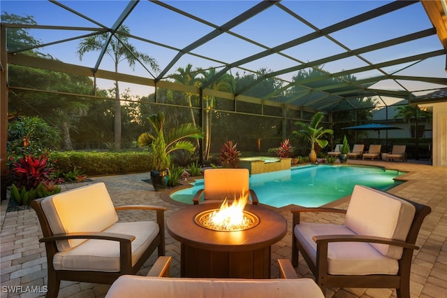 4249 Deephaven Ln, Naples, FL 34119 - view of pool featuring a fire pit, a patio area, a pool with connected hot tub, and glass enclosure