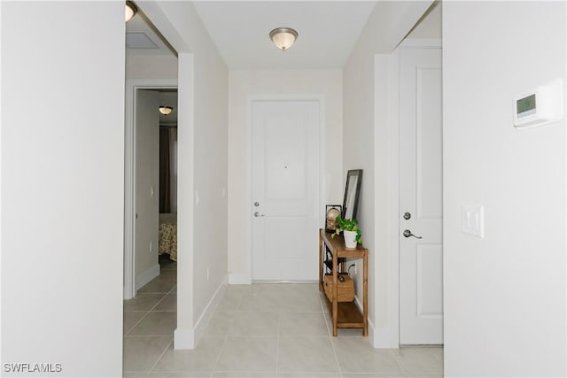 5633 Cassidy Ln, Ave Maria, FL 34142 - corridor featuring light tile patterned floors and baseboards