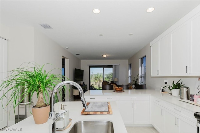 5633 Cassidy Ln, Ave Maria, FL 34142 - kitchen featuring light countertops, white cabinets, a peninsula, and recessed lighting