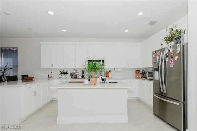 5633 Cassidy Ln, Ave Maria, FL 34142 - kitchen featuring stainless steel fridge with ice dispenser, a center island, light countertops, white cabinetry, and recessed lighting