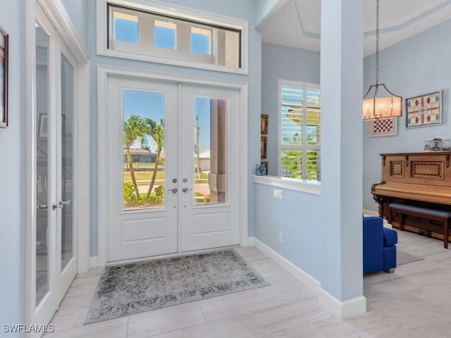 811 Manor Ter, Marco Island, FL 34145 - foyer with french doors, a chandelier, and baseboards