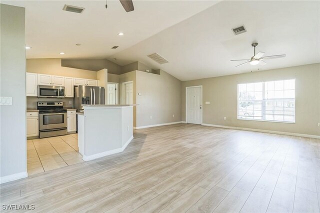 3406 27th St SW, Lehigh Acres, FL 33976 - unfurnished living room featuring ceiling fan, light wood-style floors, lofted ceiling, and baseboards