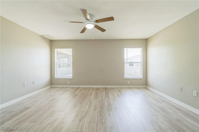 3406 27th St SW, Lehigh Acres, FL 33976 - empty room with healthy amount of natural light, a ceiling fan, light wood-type flooring, and baseboards