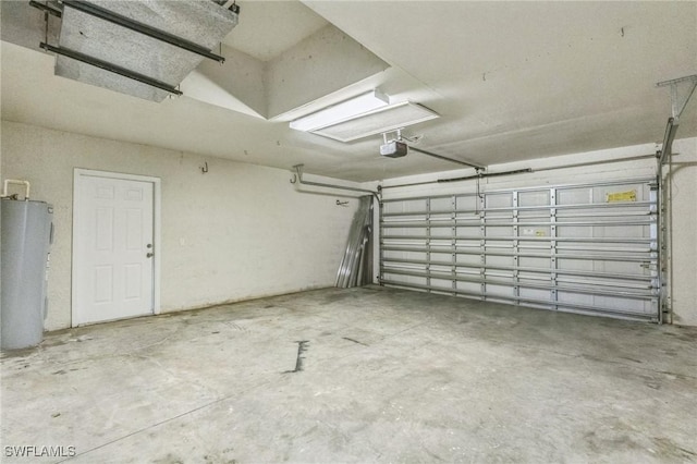 3406 27th St SW, Lehigh Acres, FL 33976 - garage with water heater and a garage door opener