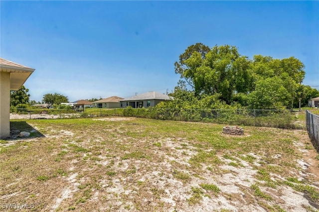 3406 27th St SW, Lehigh Acres, FL 33976 - view of yard featuring fence and an outdoor fire pit