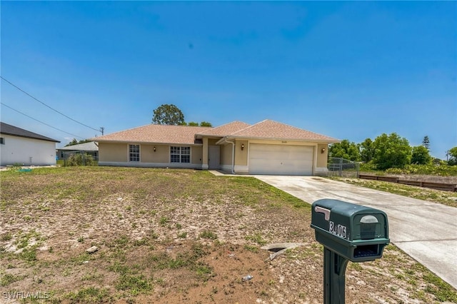 3406 27th St SW, Lehigh Acres, FL 33976 - single story home with an attached garage, stucco siding, driveway, and fence