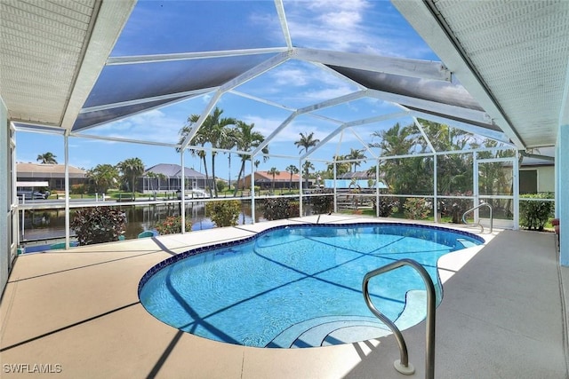 outdoor pool featuring a patio and a water view