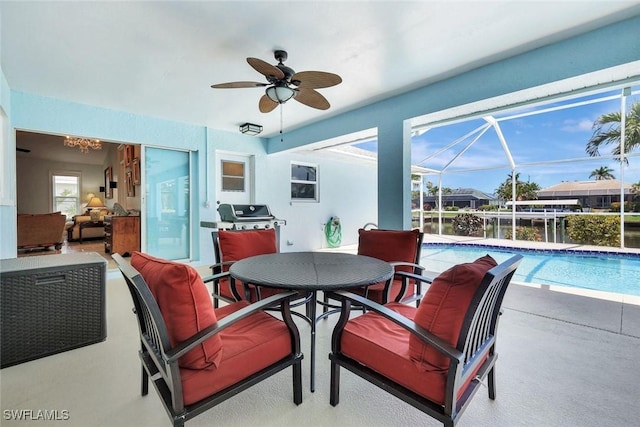 dining area featuring a sunroom and a ceiling fan