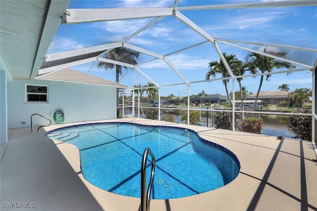 swimming pool with a water view, a patio, and a lanai