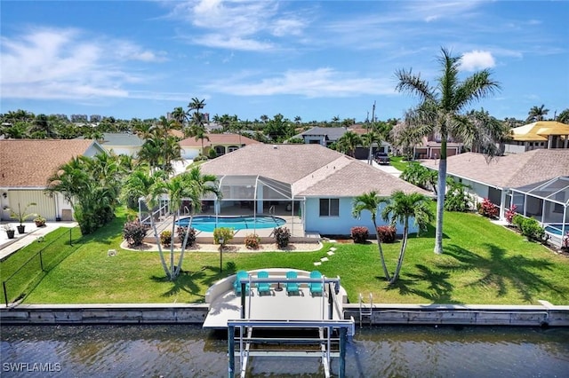 back of property with a water view, a residential view, an outdoor pool, a lanai, and a lawn