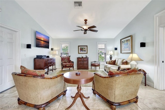 living room featuring lofted ceiling, a ceiling fan, and baseboards