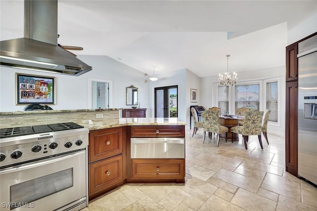 kitchen featuring appliances with stainless steel finishes, a warming drawer, island exhaust hood, a chandelier, and lofted ceiling