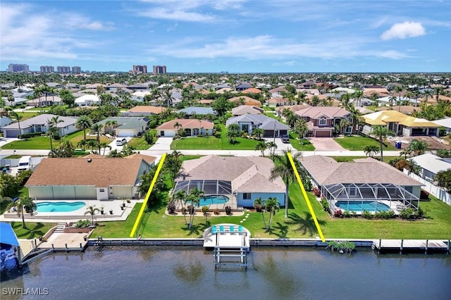 aerial view of residential area with a pool area and a large body of water