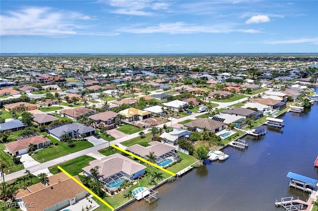 aerial view of residential area featuring a nearby body of water