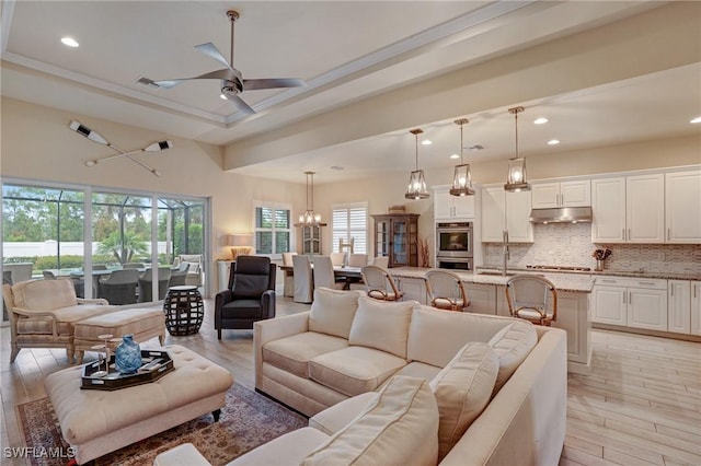 9292 Cayman Dr, Naples, FL 34114 - living area featuring recessed lighting, a ceiling fan, light wood-style flooring, and a chandelier