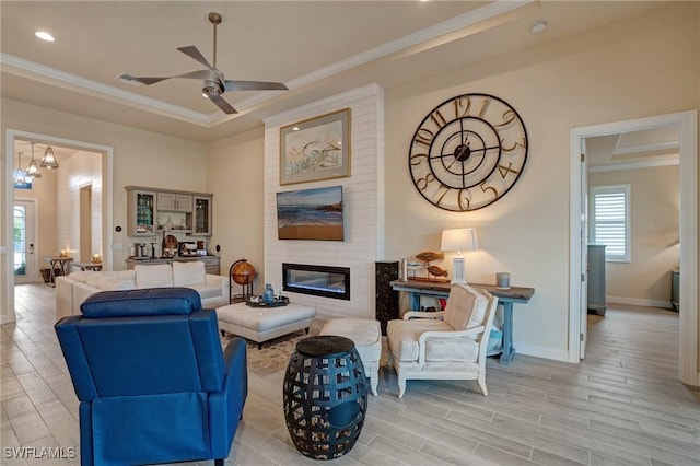9292 Cayman Dr, Naples, FL 34114 - living room with ornamental molding, a ceiling fan, light wood finished floors, a large fireplace, and baseboards
