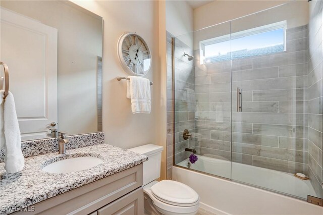 9292 Cayman Dr, Naples, FL 34114 - bathroom with toilet, vanity, and combined bath / shower with glass door