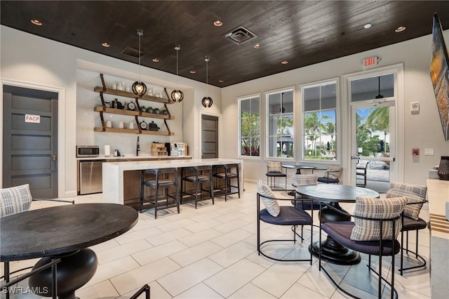 9292 Cayman Dr, Naples, FL 34114 - dining space featuring light tile patterned floors, baseboards, and wooden ceiling
