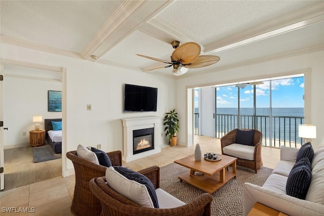 25900 Hickory Blvd Unit 504, Bonita Springs, FL 34134 - living room with ceiling fan, crown molding, a glass covered fireplace, beamed ceiling, and light tile patterned floors
