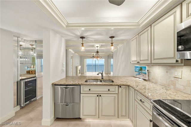 25900 Hickory Blvd Unit 504, Bonita Springs, FL 34134 - kitchen with beverage cooler, cream cabinets, a sink, a tray ceiling, and light tile patterned floors