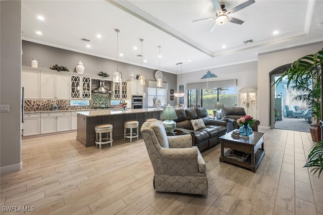 23268 Sanabria Loop, Bonita Springs, FL 34135 - living room featuring a ceiling fan, light wood-style floors, recessed lighting, and a raised ceiling