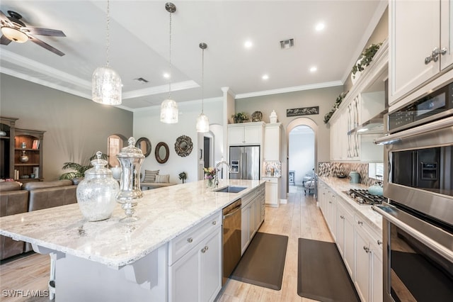 23268 Sanabria Loop, Bonita Springs, FL 34135 - kitchen with appliances with stainless steel finishes, a sink, a large island with sink, light wood-type flooring, and ornamental molding