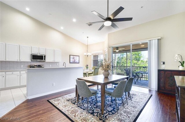 13891 Lake Mahogany Blvd Unit 3123, Fort Myers, FL 33907 - dining room with a ceiling fan, high vaulted ceiling, a chandelier, light wood-style flooring, and recessed lighting