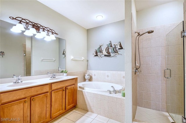 13891 Lake Mahogany Blvd Unit 3123, Fort Myers, FL 33907 - bathroom featuring tile patterned flooring, a stall shower, a garden tub, and double vanity