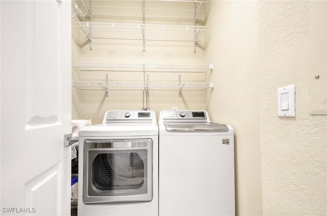 13891 Lake Mahogany Blvd Unit 3123, Fort Myers, FL 33907 - clothes washing area featuring washing machine and clothes dryer and a textured wall