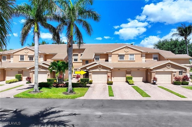 13891 Lake Mahogany Blvd Unit 3123, Fort Myers, FL 33907 - view of property with stucco siding, a tiled roof, and driveway